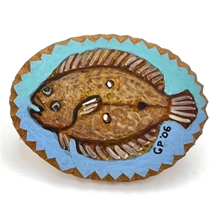 Painted masonite studio button of a flounder fish. 