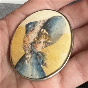 HUGE oval painting of a woman in huge hat set in silver button.