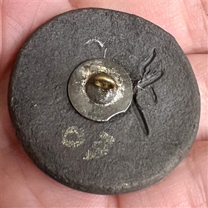 “Moon Face ceramic studio button.