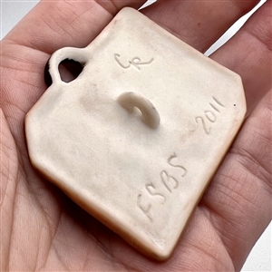 Ceramic studio button of a travel bag - favor button for FSBS 2011.