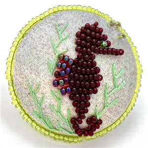 Beaded fabric studio button of a sea horse by Kate McDermott.