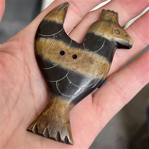 HUGE carved button of a stylized bird.