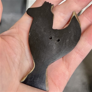 HUGE carved button of a stylized bird.