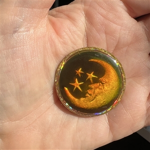 Card of five astronomical buttons including Nancy Dubois hologram crescent man in the moon.