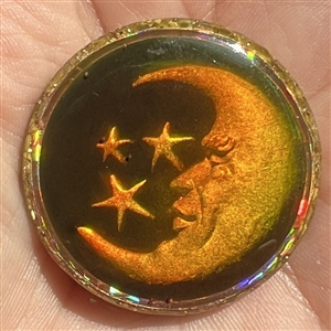 Card of five astronomical buttons including Nancy Dubois hologram crescent man in the moon.