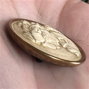 Ivoroid button of young man in 16th century costume.