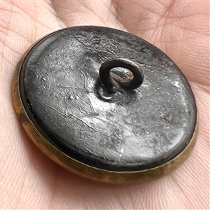 Ivoroid button of young man in 16th century costume.