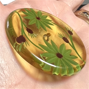 Vintage reverse carved apple juice Bakelite button of flowers.