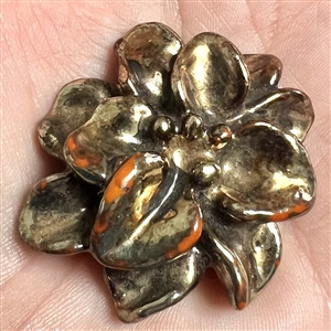 Vintage metalized British Bakelite button of realistic flower.