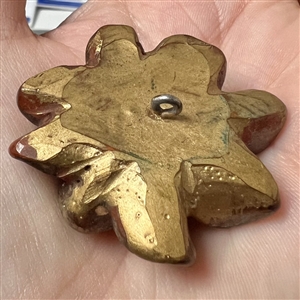 Vintage metalized British Bakelite button of realistic flower.