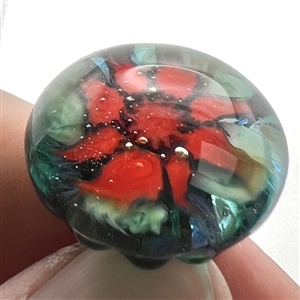 Mary Gaumond's torch-worked glass studio button of red flower.