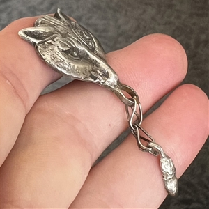 White metal button of a fox head with movable acorn.