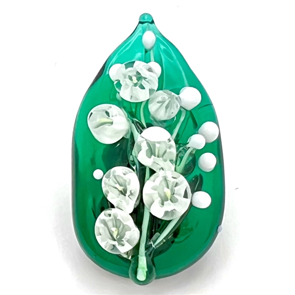 Mary Gaumonds white "lily of valley" flowers on a leaf studio button.