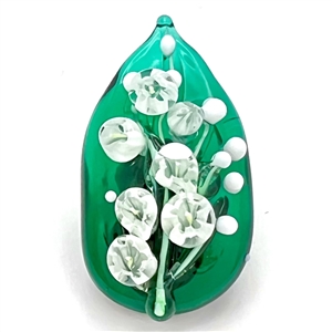Mary Gaumonds white "lily of valley" flowers on a leaf studio button.