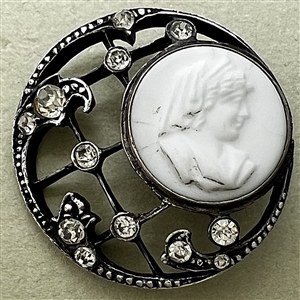 Unusual button of milk glass set in metal with pastes.