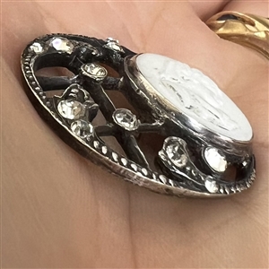 Unusual button of milk glass set in metal with pastes.