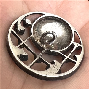 Unusual button of milk glass set in metal with pastes.
