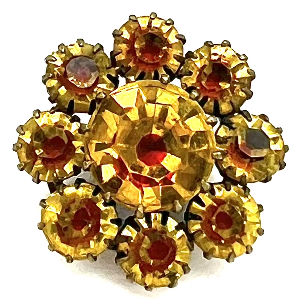 Unusual yellow faceted glass with “red flash" set in metal button. 