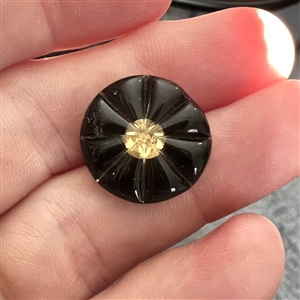 Starburst kaleidoscope button with molded radial top.