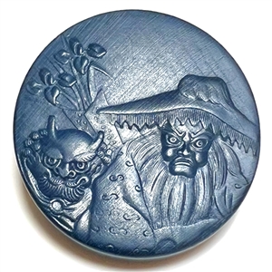 Painted wood button of an old woman and a demon. 