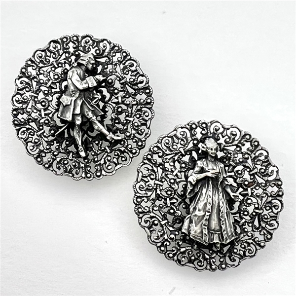Two French white metal buttons of a courting couple.