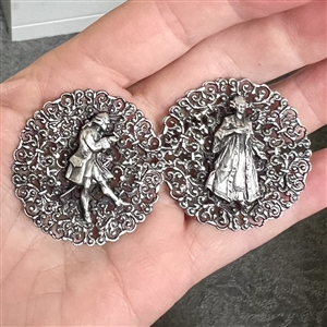 Two French white metal buttons of a courting couple.