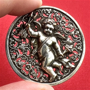 Silvered brass button of cupid.