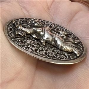 Silvered brass button of cupid.