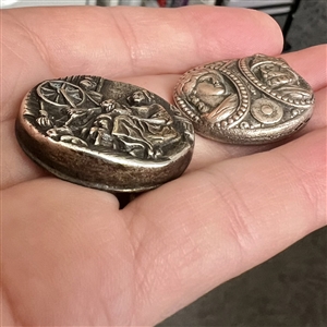 Two stamped and silvered brass buttons - one is “Bedtime Story.