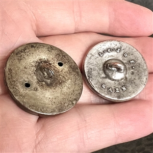 Two stamped and silvered brass buttons - one is “Bedtime Story.