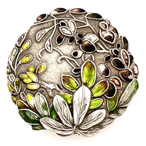 Japanese enamel button of flowers in a garden.