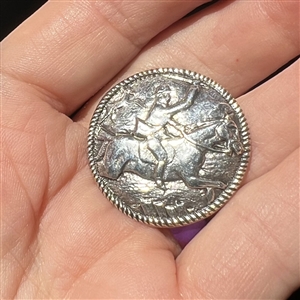 Dutch silver button of hunter riding horse with deer in background.