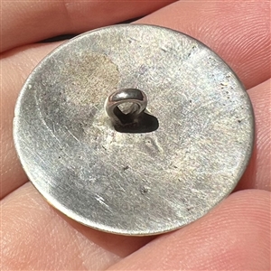 Dutch silver button of hunter riding horse with deer in background.