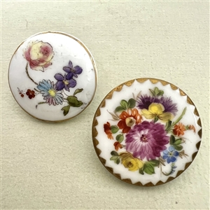 Two painted porcelain buttons of flowers. 