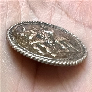 Dutch silver button of men carrying grapes.