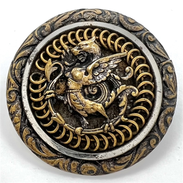 Brass button of a dragon standing.