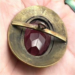 Gay 90's faceted amethyst glass set in metal button.