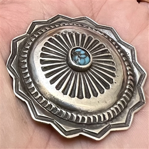 Native American silver button with turquoise center.