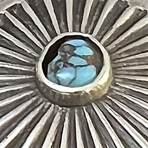 Native American silver button with turquoise center.