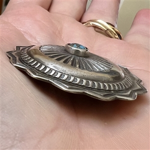 Native American silver button with turquoise center.