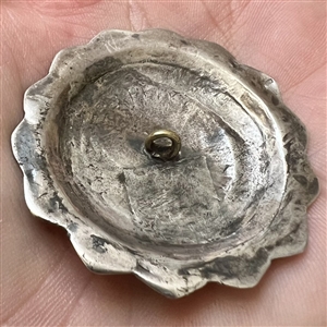 Native American silver button with turquoise center.