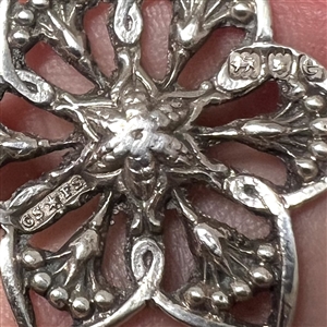 Two silver with openwork buttons of flowers.