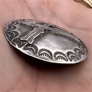 Modern Native American silver button of crossed arrows.