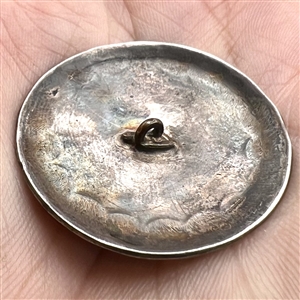 Modern Native American silver button of crossed arrows.
