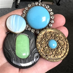 Four imitation gemstone glass in metal buttons. 