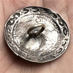 Modern Native American silver button of a horse head.