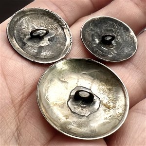 Three modern Native American silver buttons with assorted images.