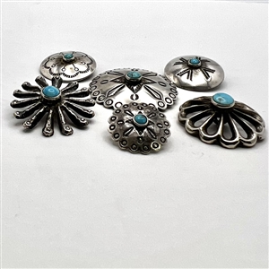 Six Native American silver buttons with turquoise centers.
