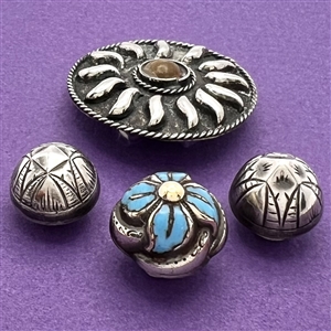 Four assorted Mexican and Native American silver buttons.