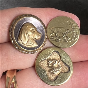 Three sporting buttons of dogs and a fox (?).